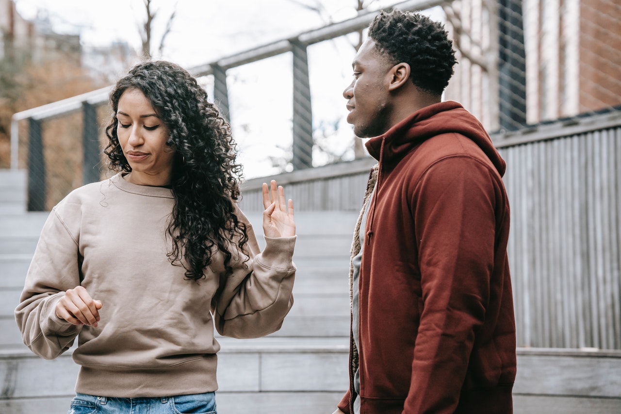 Man and woman ending argument as woman walks away